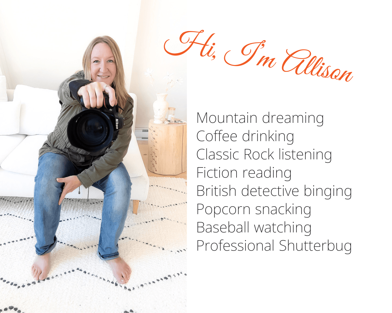 blond femaile brand photographer sitting on a white couch, holding out a Nikon camera. She is wearing an olive jacket and blue jeans, with bare feet