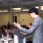 man at podium giving MC speech at CAPSI dinner, Westin Hotel ballroom, Halifax