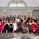 group photo of large group in formal wear