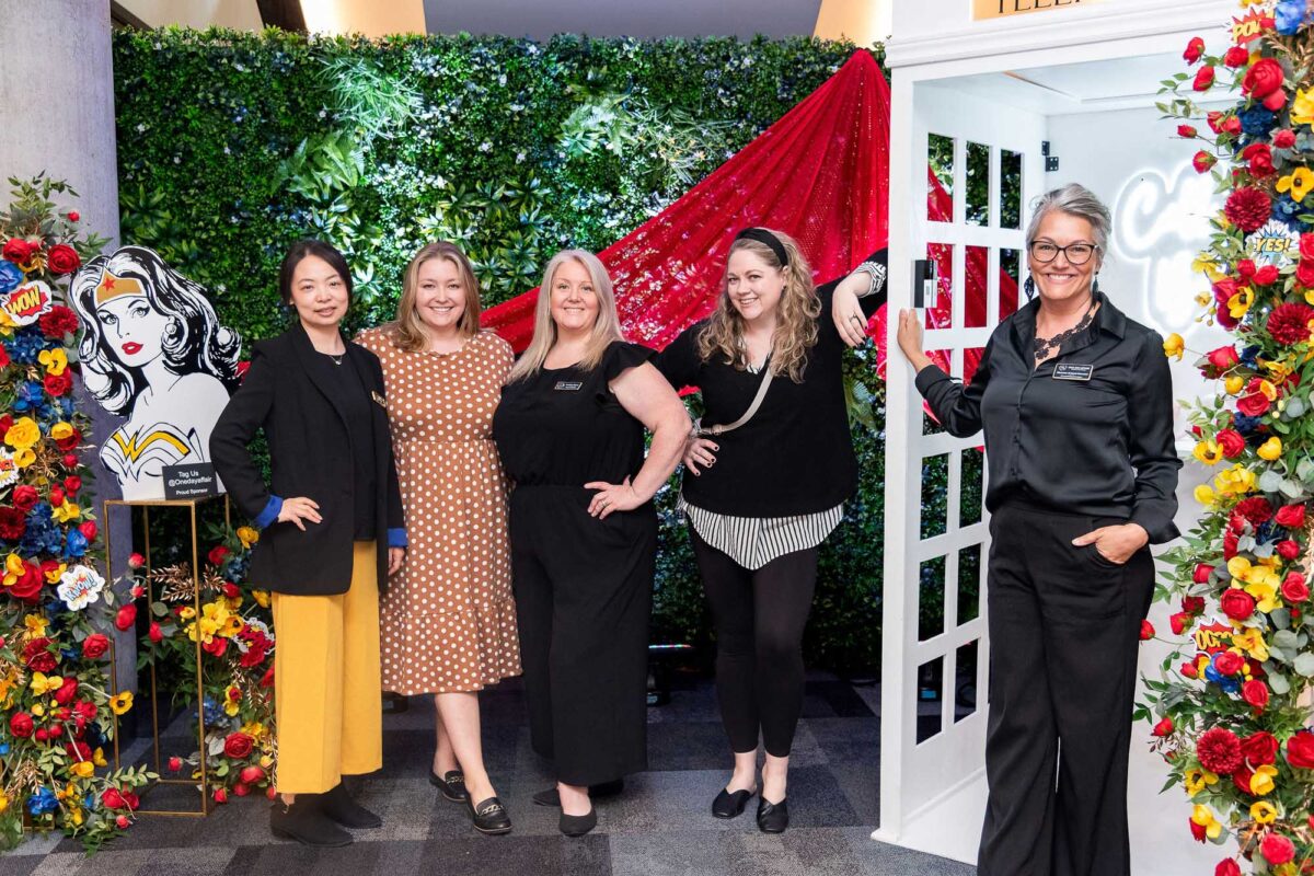 group shot of 5 women at the photo booth wall at the Halifax Wonder Women Conference