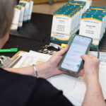 over the shoulder look of a mobile photos show event registration checkin app