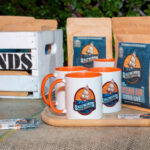Product photo of 2 coffee bags and 3 mugs logo'd Saltwind Coffee Company