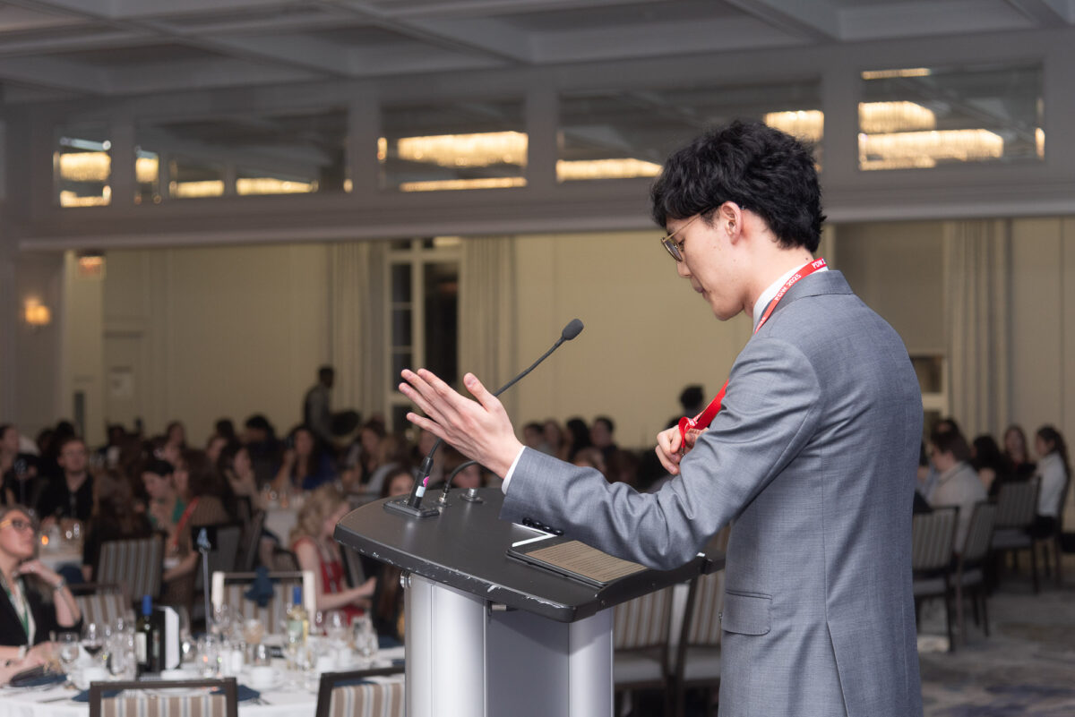 man at podium giving MC speech at CAPSI dinner, Westin Hotel ballroom, Halifax