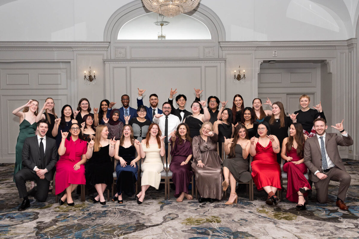 group photo of large planning committee in formal wear