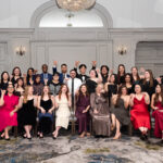 group photo of large planning committee in formal wear