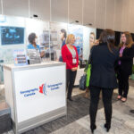 4 women gathering at Sonography Canada booth in trade show at Halifax Convention Centre