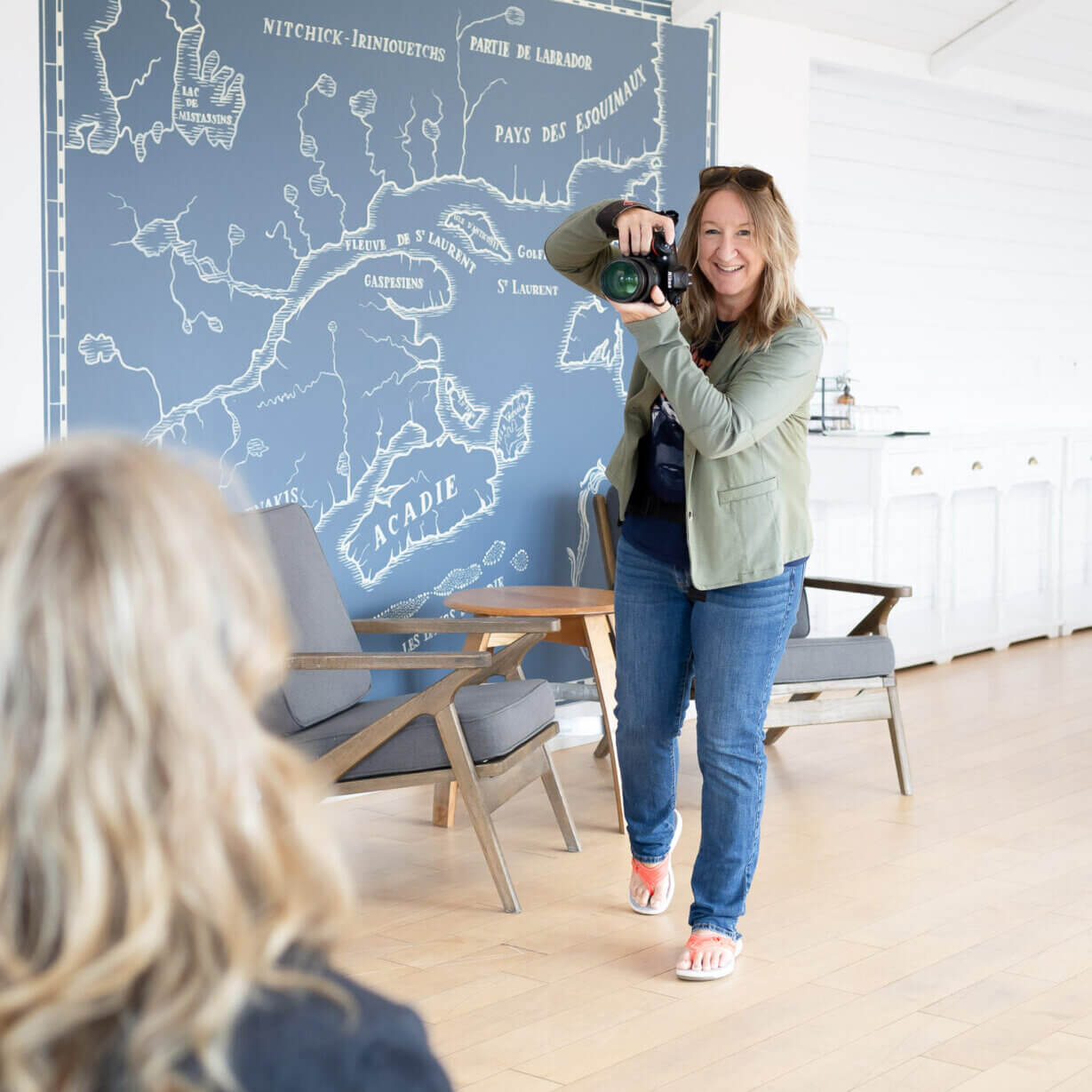 Allison Smith is a blond female photographer in jeans and olive green jacket ready to photograph a women in denim jacket during a brand mini session